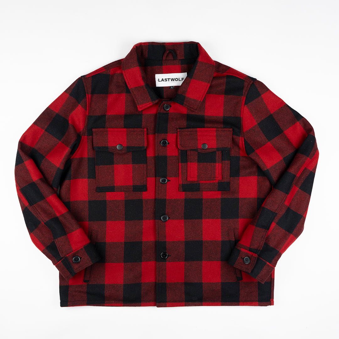 Red and black checkered shirt with brand label on a white background