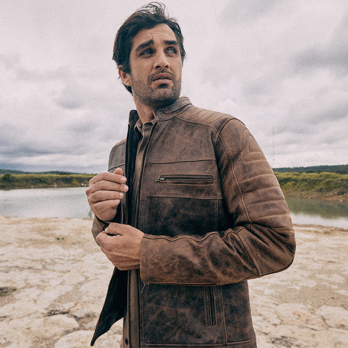Man wearing a brown Last Wolf leather racer jacket outdoors